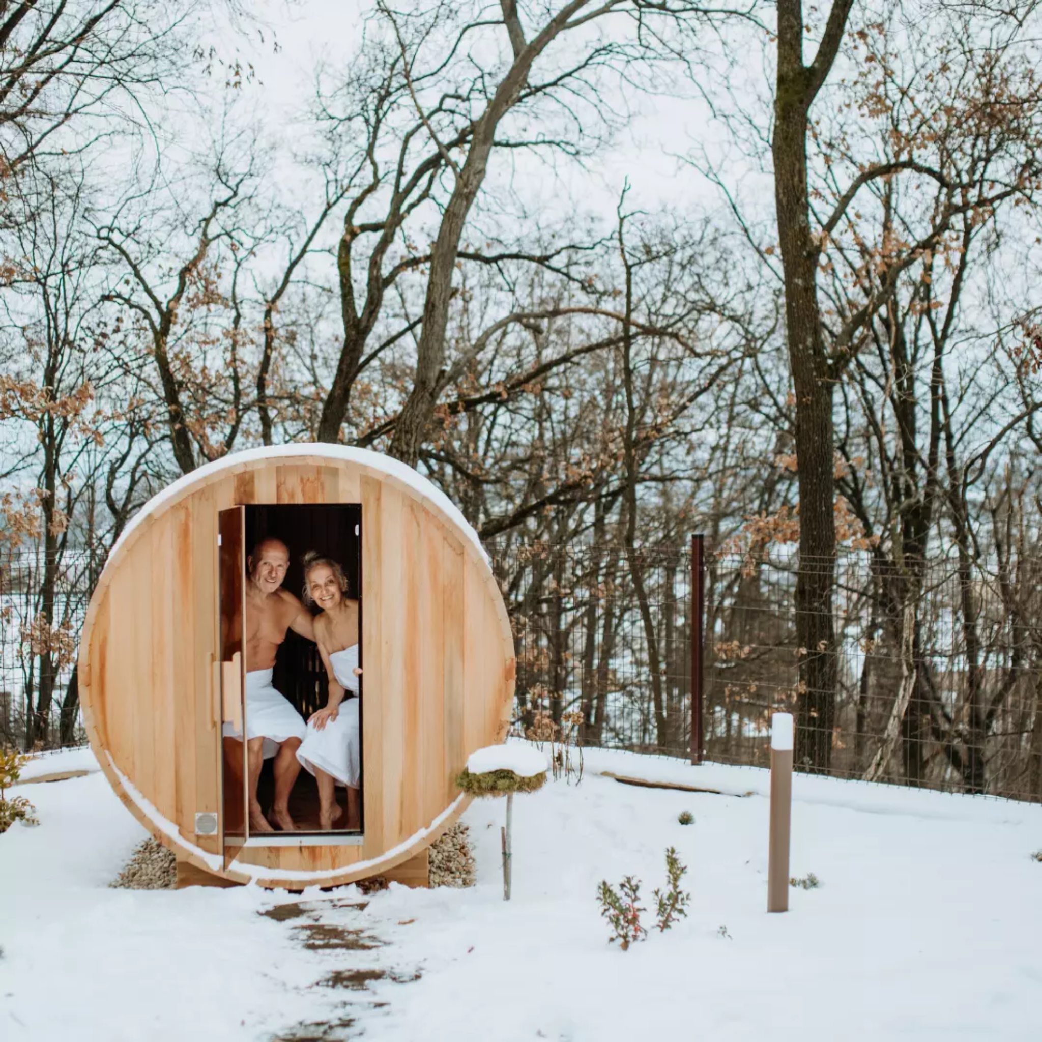 Outdoor barrel sauna in the snow at night